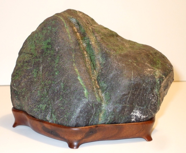 #67 Chromite stone with green veins on old walnut daiza 6" x 5" tall $200